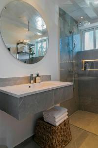 a bathroom with a sink and a mirror at Modern Holiday Home Where Indoor And Outdoor Merge in Hals
