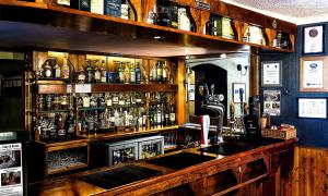 a bar with a lot of bottles of alcohol at Invergarry Hotel in Invergarry