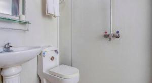 a white bathroom with a sink and a toilet at PAI Hotel Shijiazhuang Luquan Zoo in Shijiazhuang