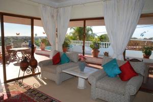 a living room with two couches and a table at Genies Villa Boutique Algarve in Almancil