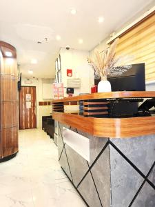 a lobby with a counter in a room at El Grande Inn Piy Margal Sampaloc Manila in Manila