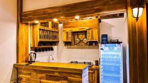 a kitchen with wooden cabinets and a refrigerator at Dunya Villa in Gili Islands