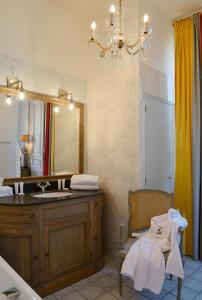 a bathroom with a sink and a mirror at Hotel Villa Reine Hortense in Dinard