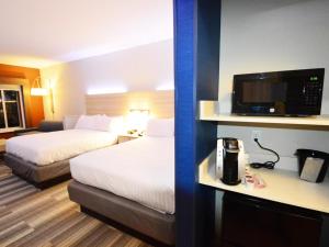 a hotel room with two beds and a television at Holiday Inn Express & Suites Toledo South - Perrysburg by IHG in Perrysburg Heights +32 photos