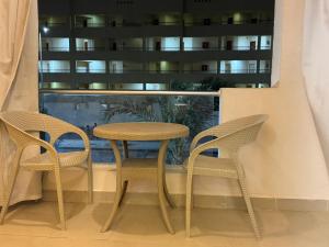 a table and two chairs in front of a window at كمباوند فلورينزا 50 in Hurghada