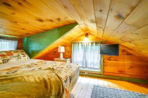 a bedroom with a bed in a wooden ceiling at On 30 Acres with Trails and Garden Stockholm Retreat! in Stockholm