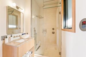 a bathroom with a sink and a shower at Offshore Montauk in Montauk +18 photos