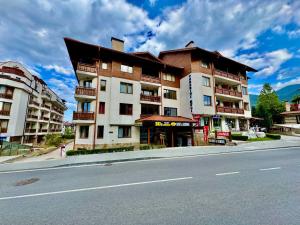 a large building on the side of a street at Todorini Kuli Apartments in Bansko