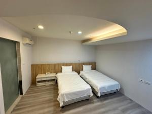 Posteľ alebo postele v izbe v ubytovaní Xingyi Hotel