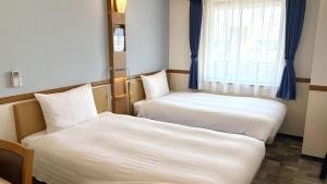 Postel nebo postele na pokoji v ubytování Toyoko Inn Wako-shi Ekimae