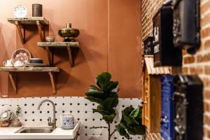 a kitchen with a sink and a counter with shelves at Origin Antique House and Hotel in Guangzhou +223 photos