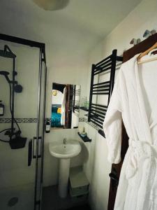 a white bathroom with a sink and a shower at Casa Morayma, Lecrin, Granada in Acequias +87 photos