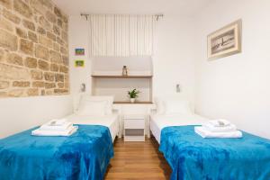 Postel nebo postele na pokoji v ubytování Agata House Hvar