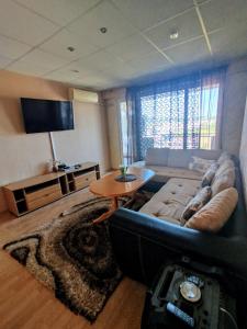a living room with a couch and a table at Galina Apartment in Kŭrdzhali