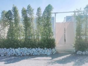 a group of trees in front of a building at 7 Class Pool Villa in Chachoengsao