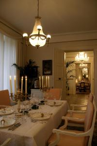 a dining room with a table and a chandelier at Château Mesny in Vic-sur-Seille