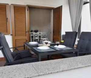a dining room table with two glasses of wine at App Meri in Savudrija