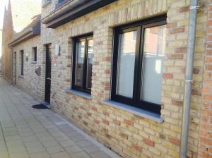 a brick building with windows on the side of it at Vakantiewoning Ijzerrust in Roesbrugge-Haringe