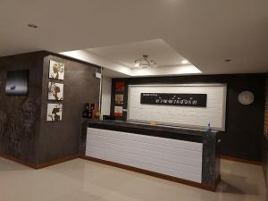 a lobby with a bar with a sign on the wall at Ban Naam Resort in Mae Sai