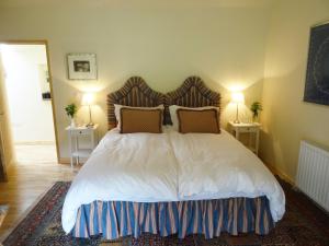 a bed with a white bedspread and pillows in a room at Hollamoor Farm in Barnstaple