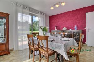 a dining room with a table and chairs at Ty lann in Pluvigner +14 photos