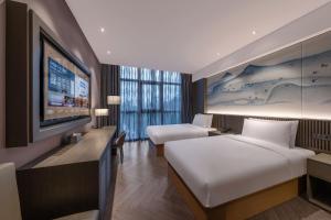 Beijing Chaoyang Park Crystal Orange Hotel房間的床