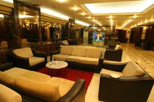 a living room with couches and chairs in a store at Akyuz Hotel in Ankara