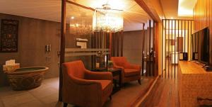 a lobby with chairs and a table in a room at The Oriental Luxury Suites Tagaytay in Luksuhin +138 photos