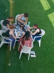 a group of people sitting at a table in the grass at Sariska Celebration Hotel & Resort in Alwar