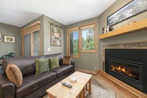 a living room with a couch and a fireplace at Iron Horse C4093 condo in Winter Park