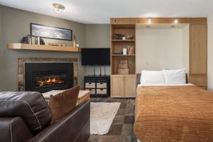 a bedroom with a bed and a fireplace at Iron Horse C4093 condo in Winter Park