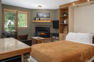 a bedroom with a bed and a fireplace at Iron Horse C4093 condo in Winter Park