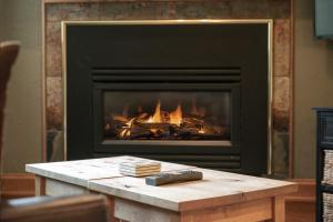 a fireplace with a table in front of it at Iron Horse C4093 condo in Winter Park