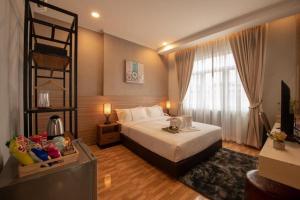 Postel nebo postele na pokoji v ubytování One Vientiane Hotel