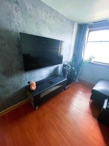 a living room with a flat screen tv on a wall at Shiraz Suite in Calgary