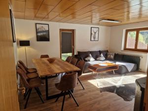 a living room with a couch and a table at Zum schwarzen Hirsch in Dalaas