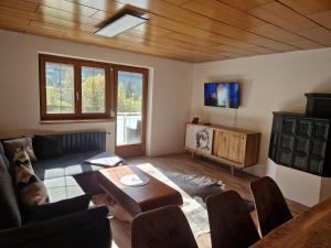 a living room with a couch and a table at Zum schwarzen Hirsch in Dalaas