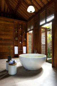 a large bathroom with a large tub in a room at Kalapa Boutique Resort & Yoga in Canggu