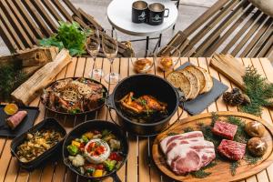 a table topped with different types of food and wine glasses at TOCORO. Mt.Fuji CAMP&GLAMPING in Fujikawaguchiko
