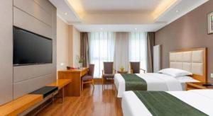 Ένα ή περισσότερα κρεβάτια σε δωμάτιο στο GreenTree Inn Shandong Taian Feicheng Xincheng Road Business Hotel +160 φωτογραφίες