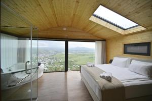a bedroom with a large bed and a glass shower at Stonehenge Hotel & Restaurant in Tsaghkadzor +51 photos