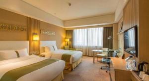 Voodi või voodid majutusasutuse Datong Hotel toas