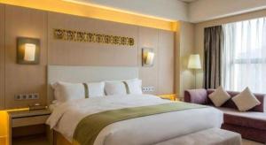 Voodi või voodid majutusasutuse Datong Hotel toas