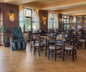 a dining room with wooden tables and chairs at Park Hotel Polykastro in Polykastro