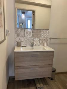 a bathroom with a sink and a mirror at La Casa Verde B&B in Trivero