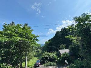 a car parked on the side of a hill with trees at Serenity Oasis Nagatoro in Nagatoro