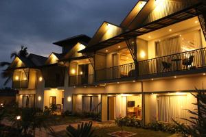 a large building with lights on it at night at Cozycaza resort in Padinjarathara