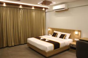 a hotel room with a bed and a window at Cozycaza resort in Padinjarathara