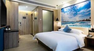 Un pat sau paturi într-o cameră la hailihotel
