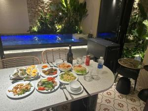 a table with several plates of food on it at 09 Villa in Can Tho